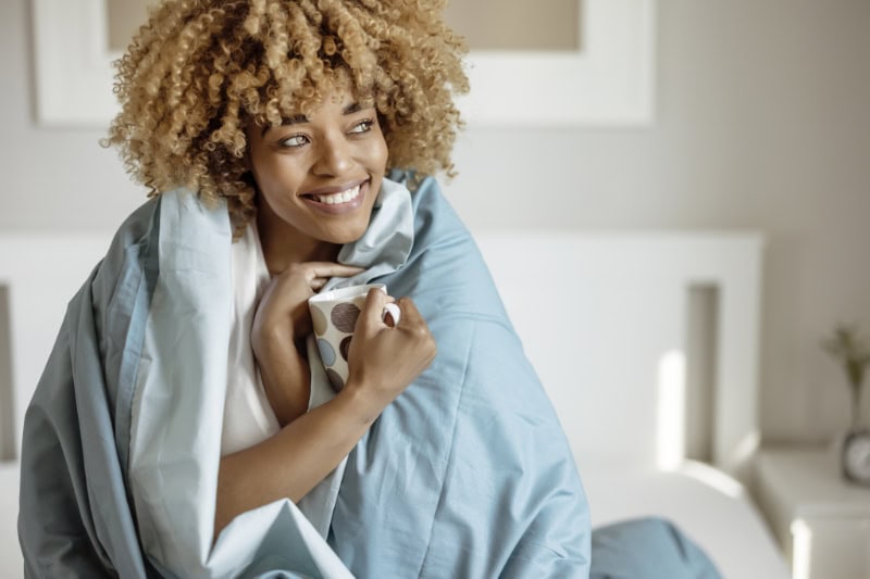 Woman Wrapped in Cozy Blanket.