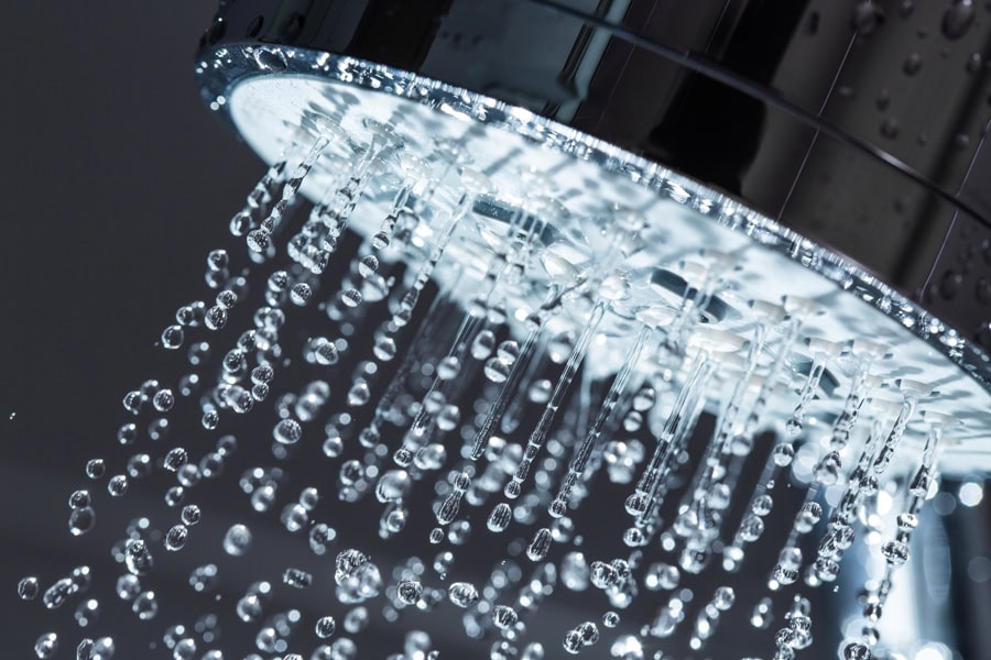 Shower head with hot water coming out.